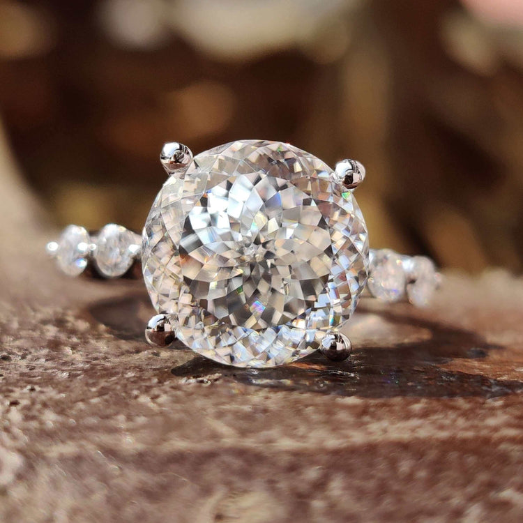 Portuguese cut moissanite engagement ring in white gold with floating bubble pave setting.