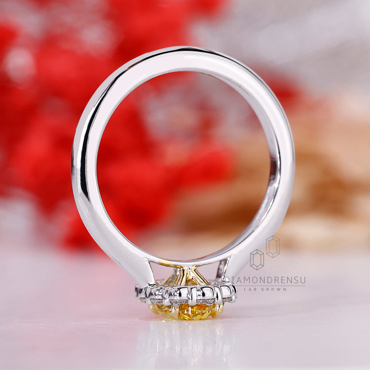 White gold ring with oval and round diamonds.