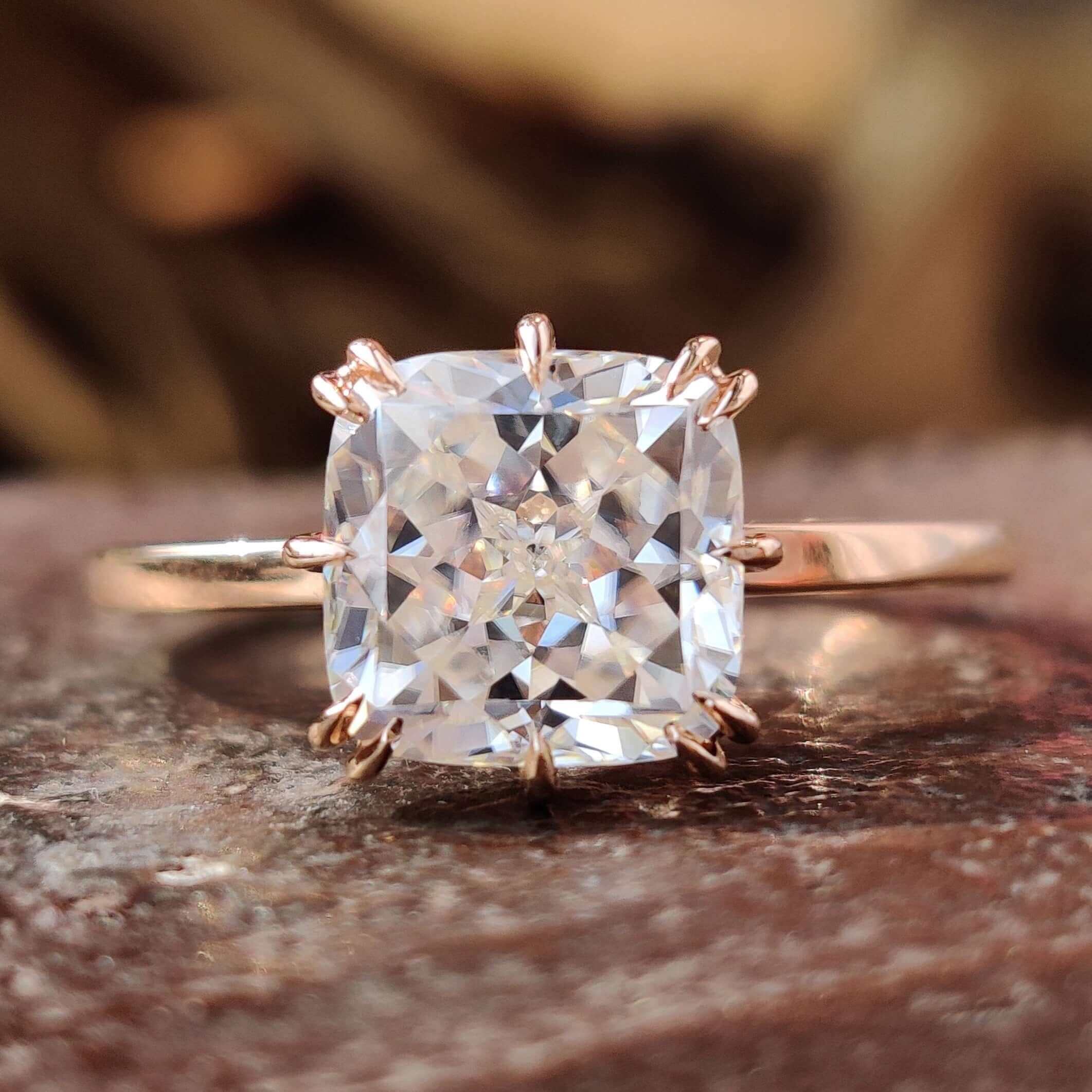 Solitaire style ring with cushion Rensu cut moissanite.