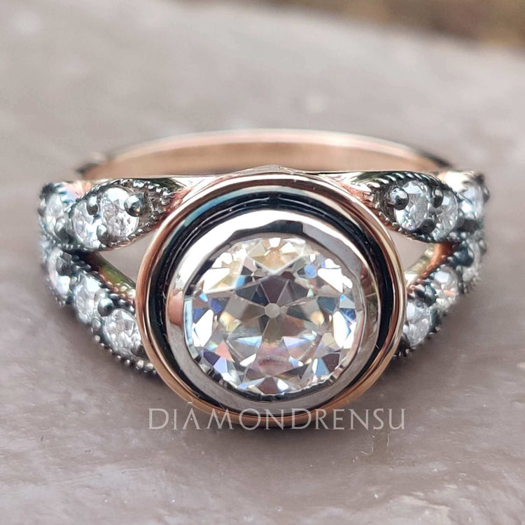 Round old mine cut moissanite engagement ring in rose gold.