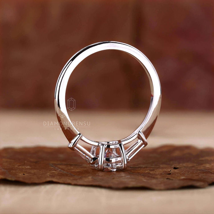 Diamond ring with tapered baguettes and a round diamond, perfect as a uk engagement ring with handmade jewellery.