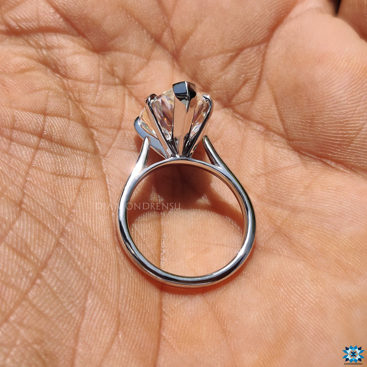 Diamondrensu UK engagement ring with pear cut moissanite and classic cathedral mount.