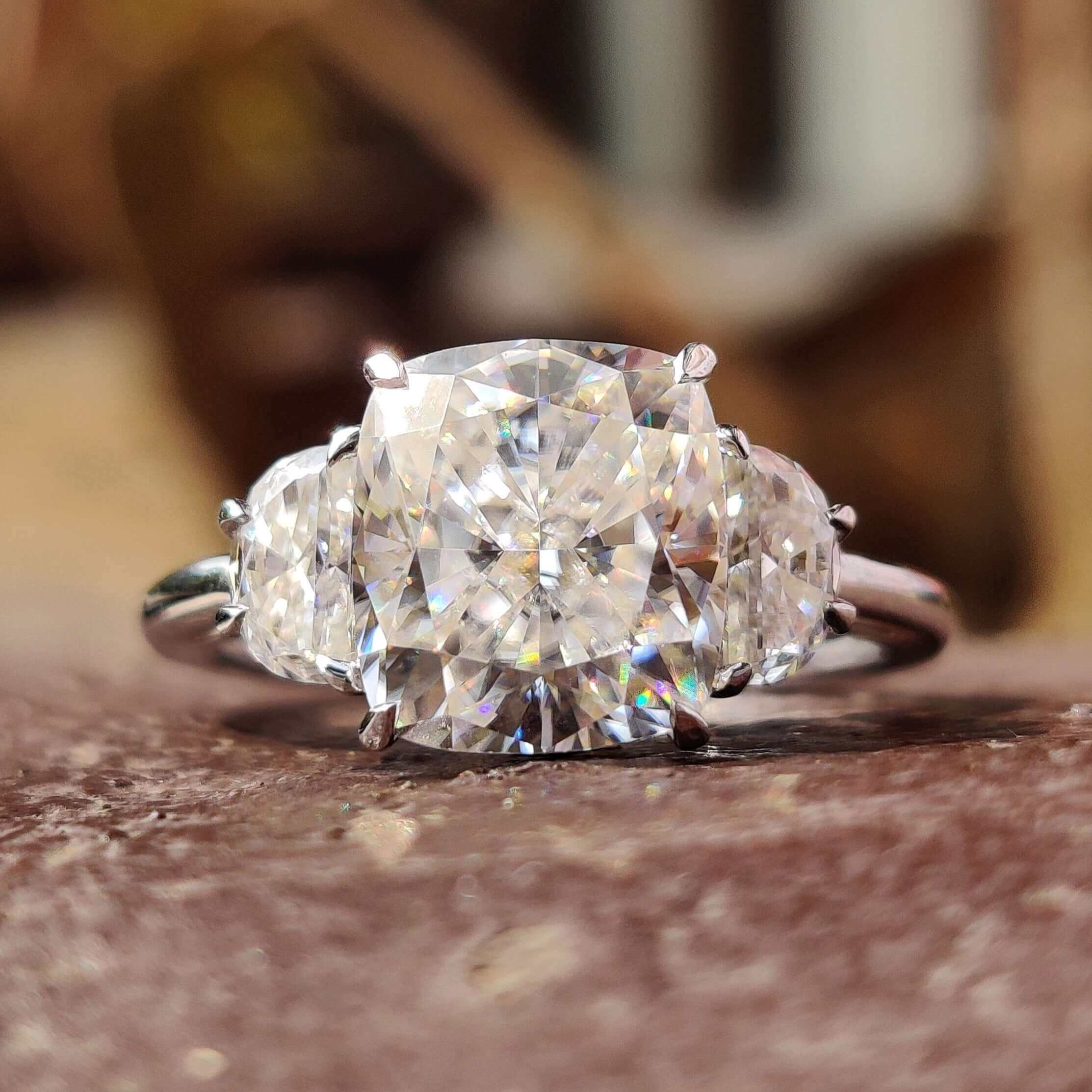 Cushion cut moissanite ring with half moon side stones.