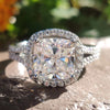 Cushion cut moissanite engagement ring in white gold.