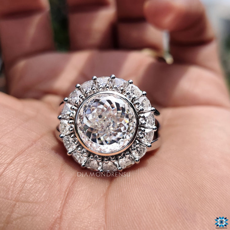 White gold engagement ring featuring vintage design and round prong setting.