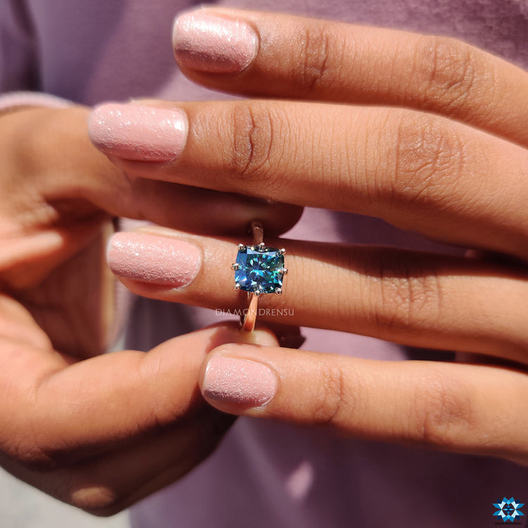 Hidden halo engagement ring with round cut and cushion moissanite centre.