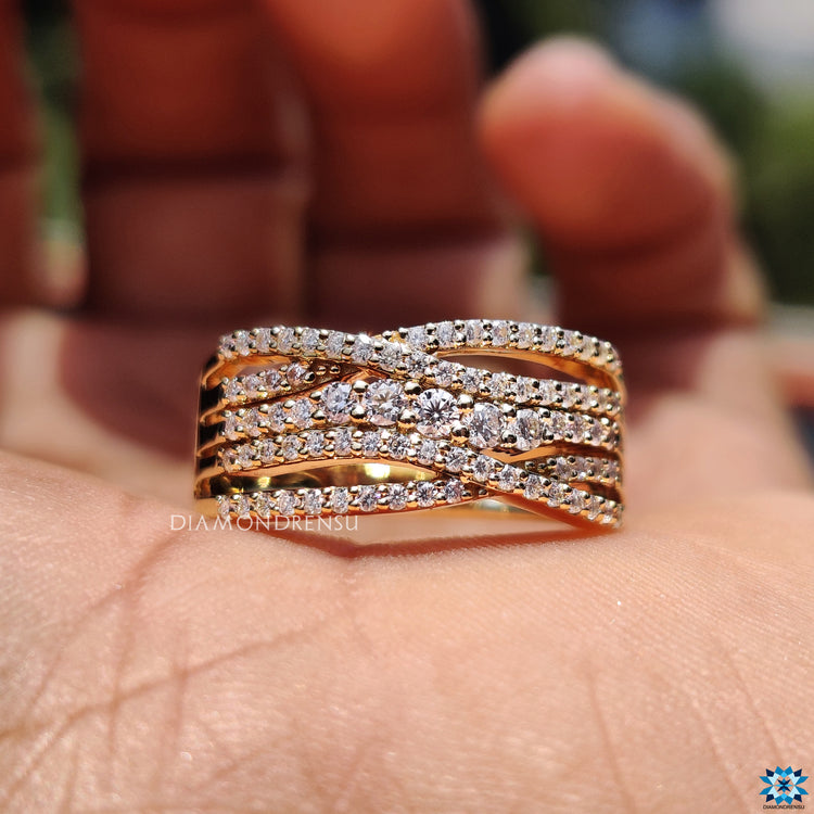 Round cut moissanite set in a criss cross pave design.