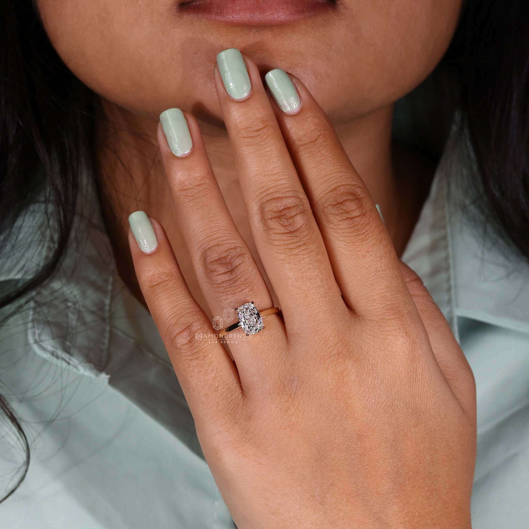 Unique elongated cushion cut lab diamond ring in a claw prong setting.