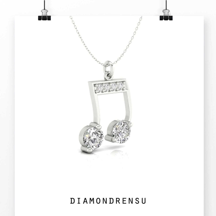 Gold music note pendant with sparkling round cut diamond.