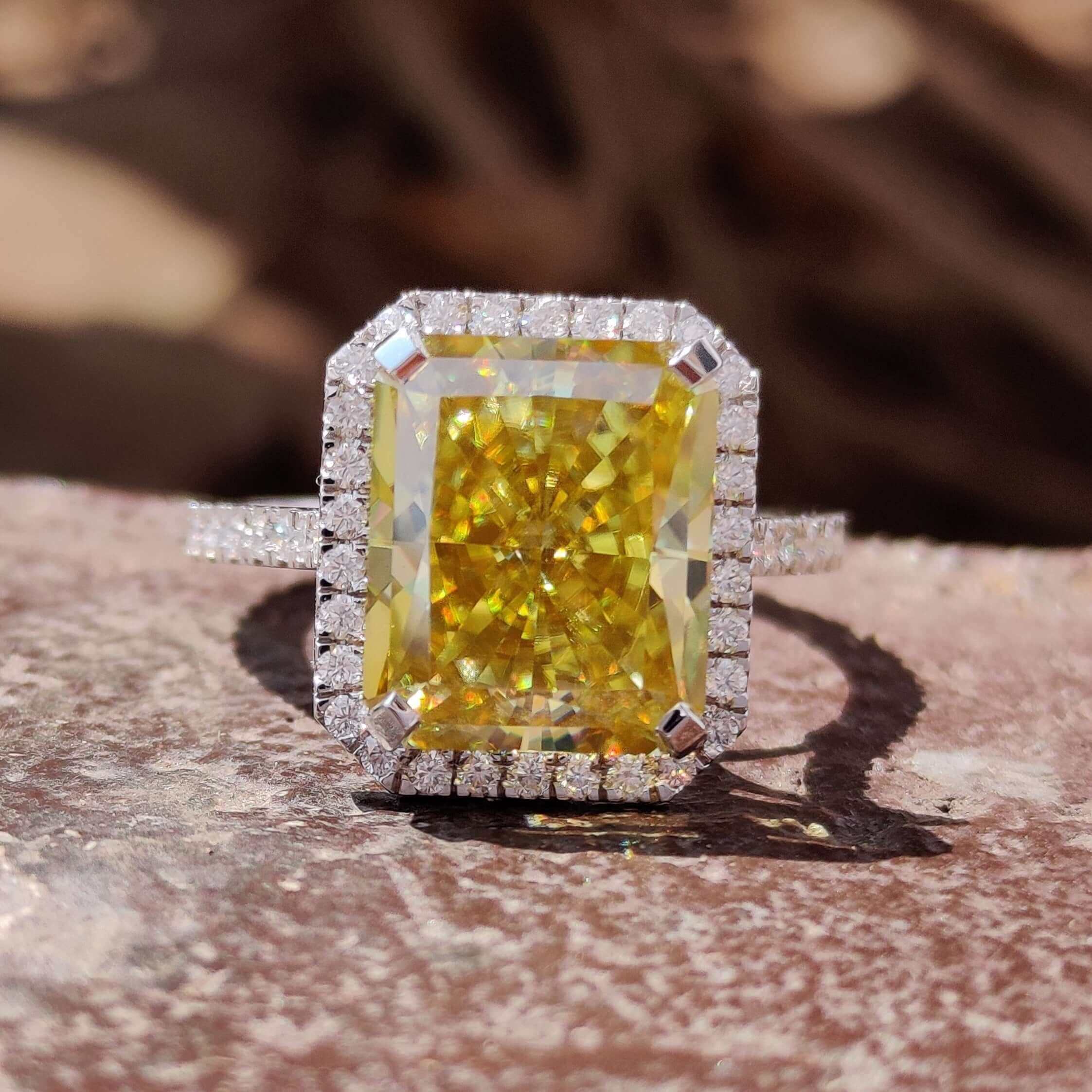 Radiant cut canary yellow moissanite ring in white gold.