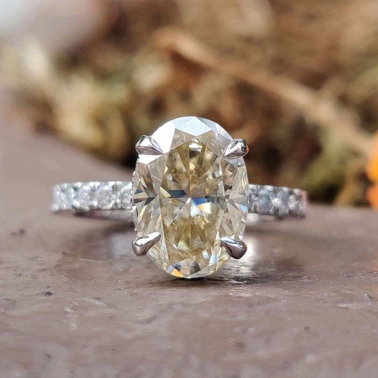 Hidden halo oval moissanite engagement ring in white gold.
