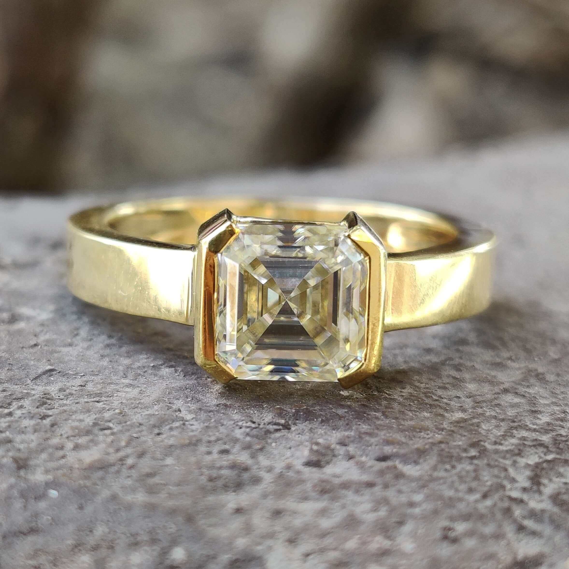 Asscher cut moissanite engagement ring in yellow gold.
