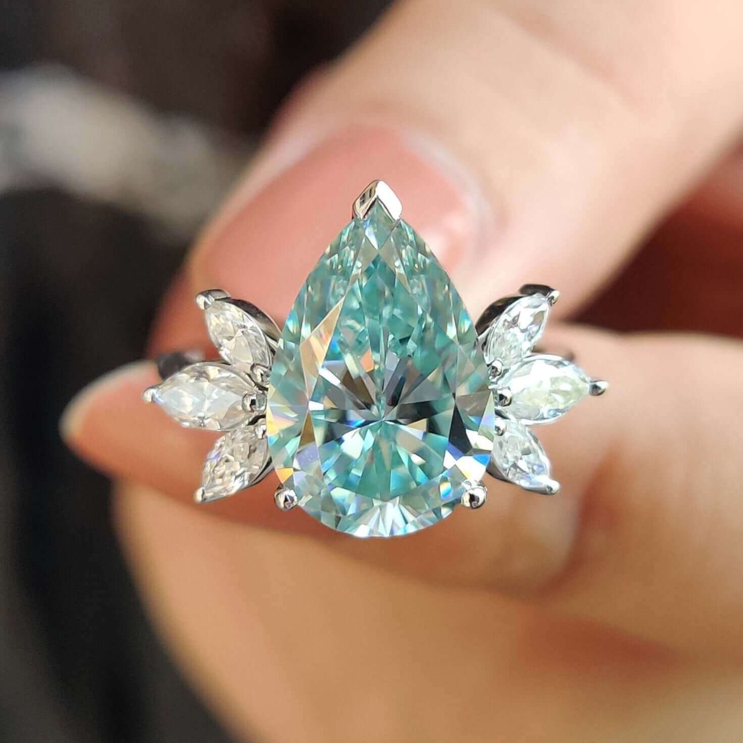 Moissanite pear engagement ring in white gold.