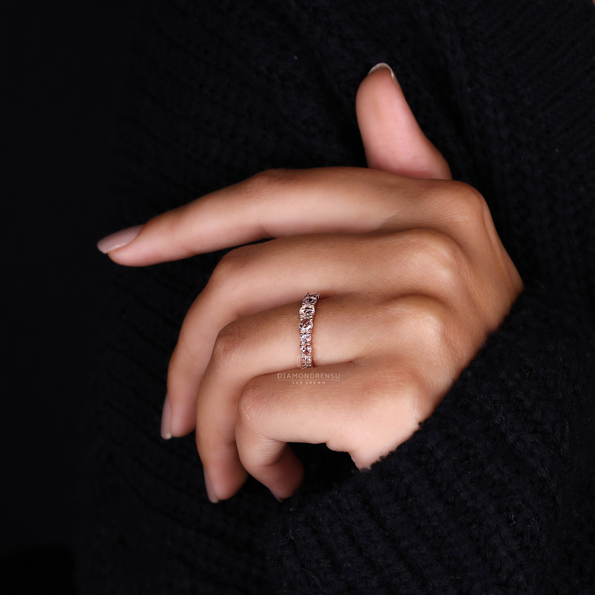 Rose gold wedding band with round diamonds.