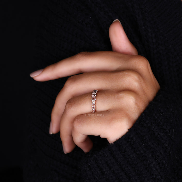 Rose gold wedding band with round diamonds.
