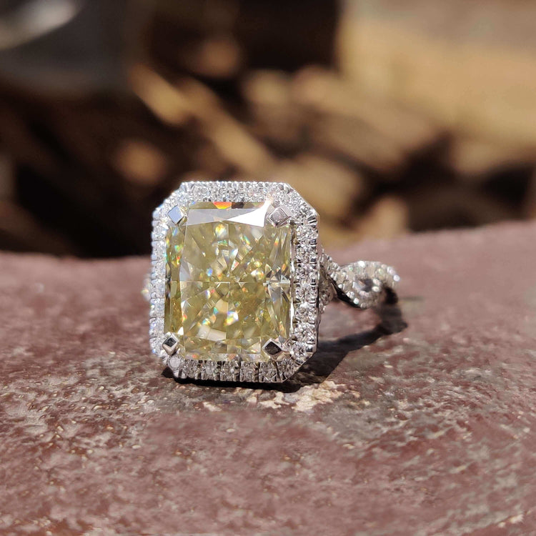 Radiant cut moissanite ring with hidden halo design.