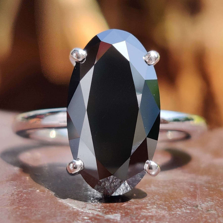 Moval cut engagement ring with hidden halo design.