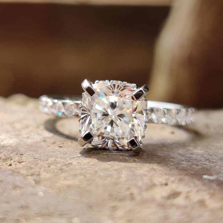 Cushion cut moissanite engagement ring with hidden halo.