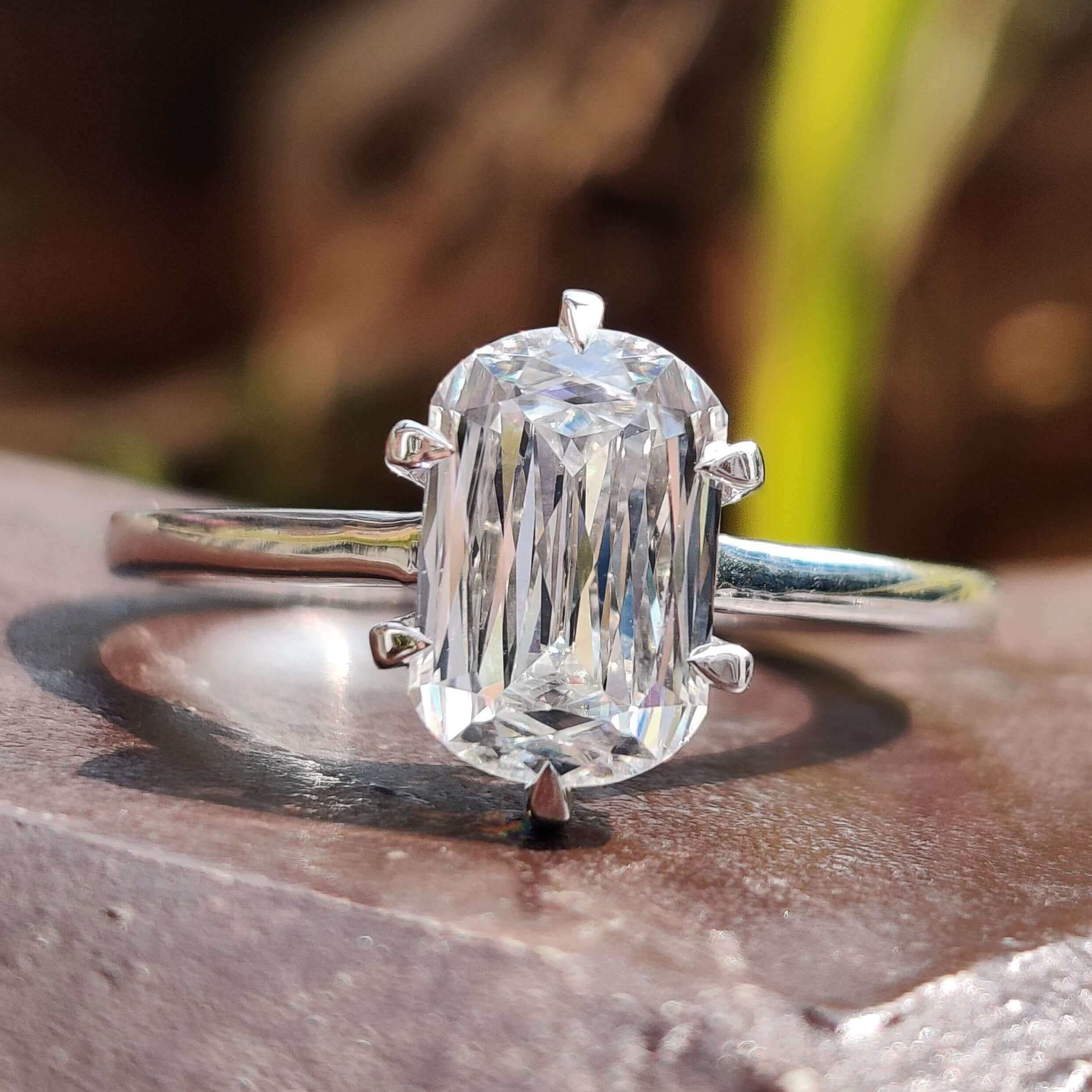Criss cut engagement ring with cushion moissanite center.