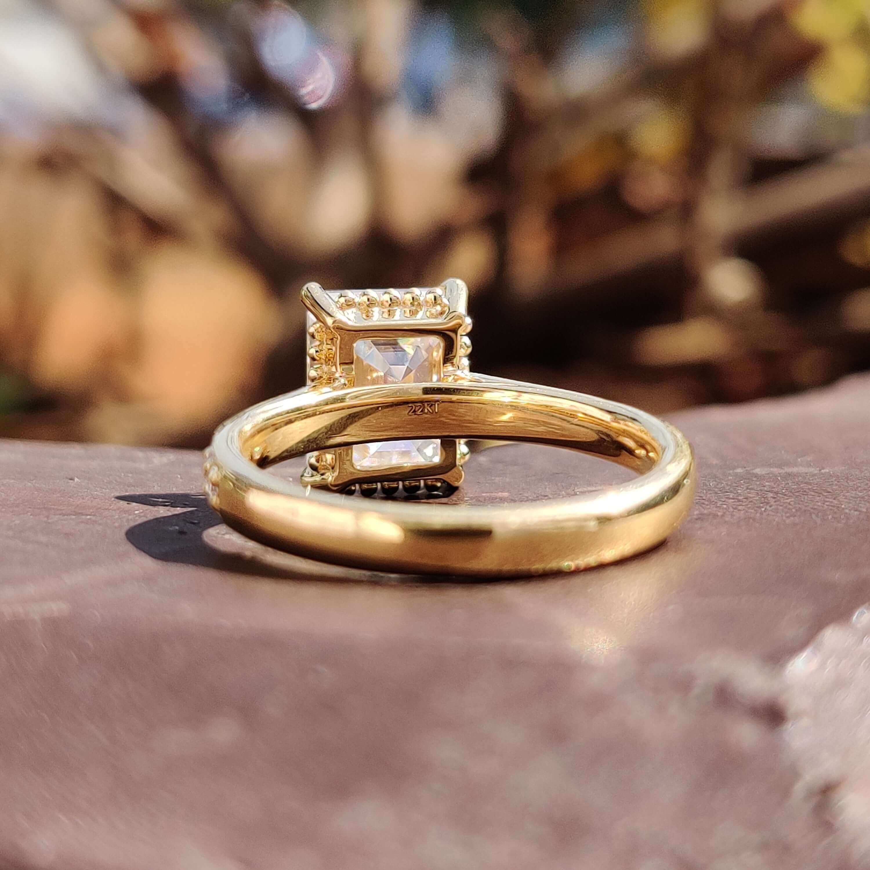 Elegant engagement ring with emerald moissanite and custom pave detailing.