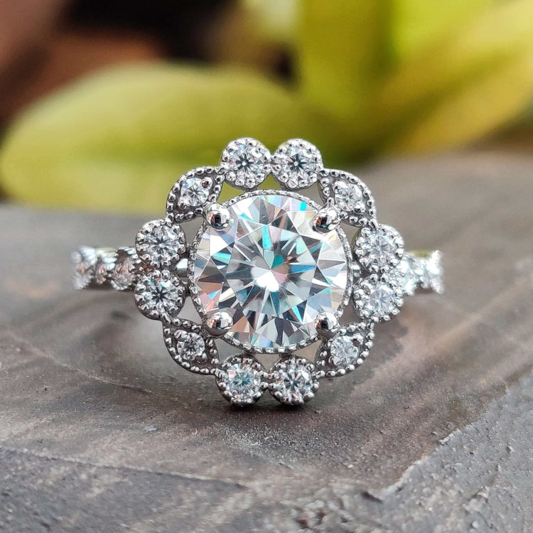 Round brilliant cut ring with sparkling moissanite set in a classic design.