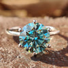 Round moissanite engagement ring in white gold with a clean solitaire setting.