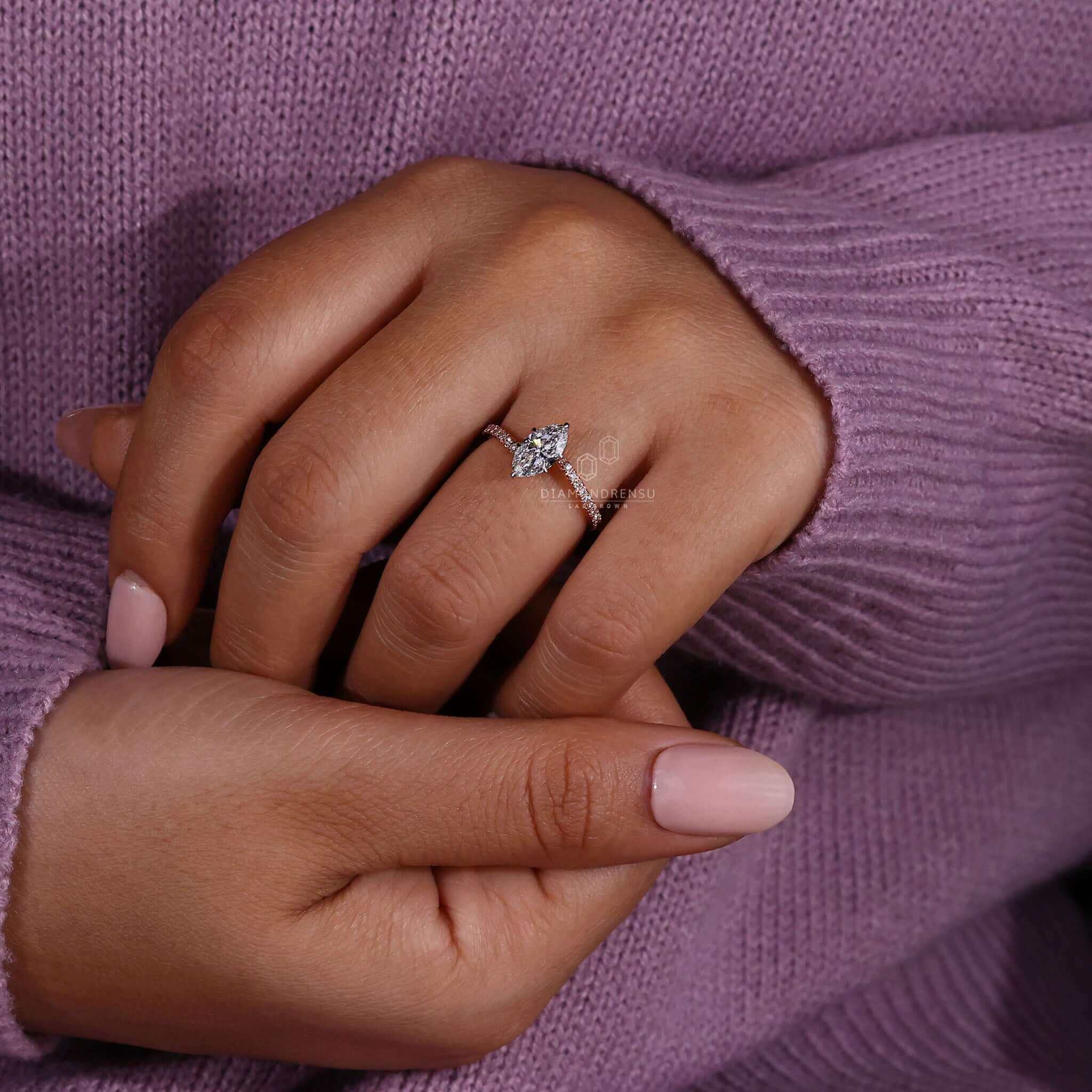 Marquise diamond engagement ring with pave diamonds and rose gold for a sophisticated and stylish look.