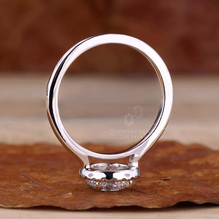 4 prong engagement ring featuring a round brilliant cut diamond in a beautiful halo ring ring style.
