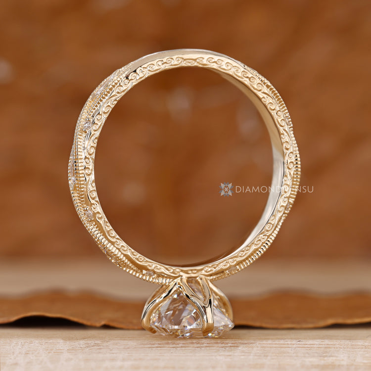 Cushion engagement ring with milgrain details and claw prongs.