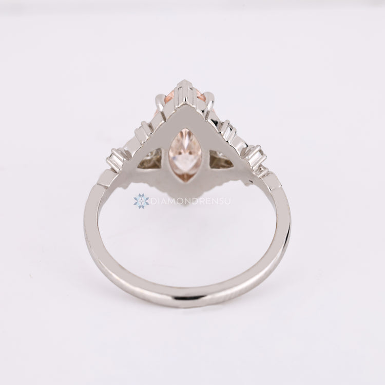 Art deco marquise engagement ring with cluster setting.