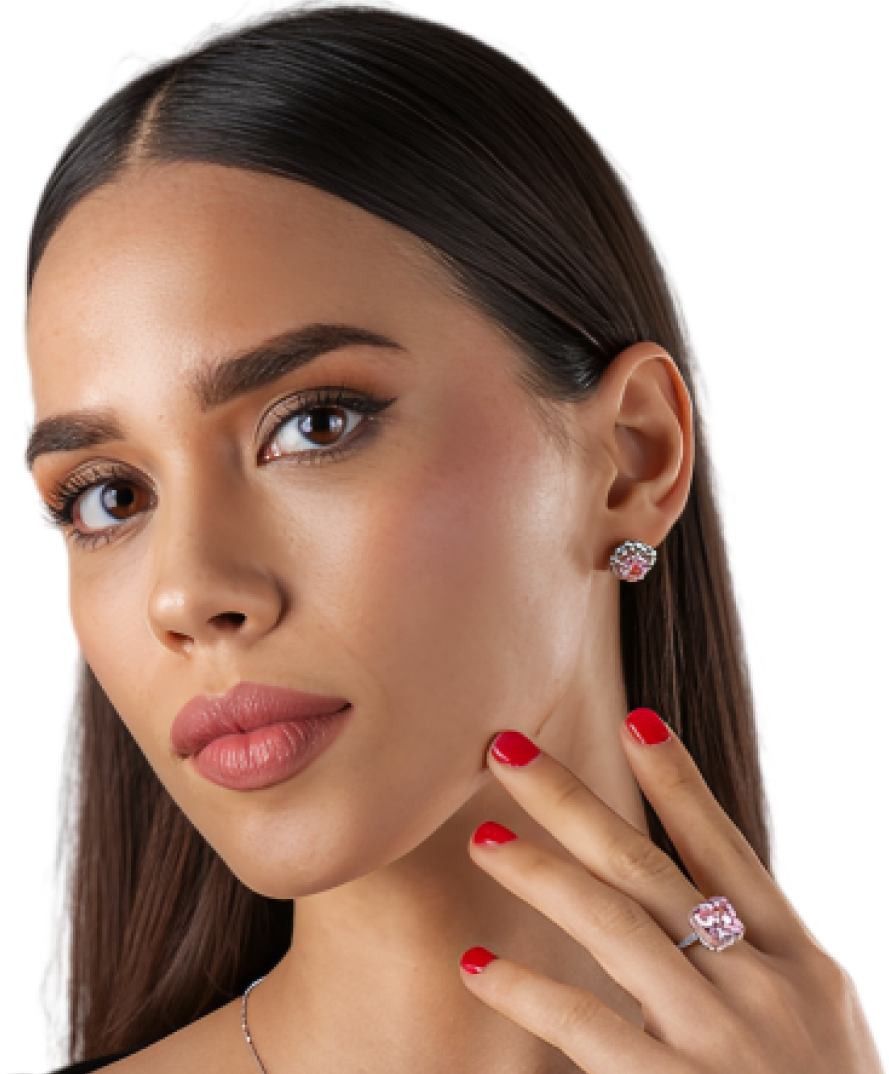 Woman wearing a matching pink gemstone ring and stud earrings set. Woman wearing a matching pink gemstone ring and stud earrings set.