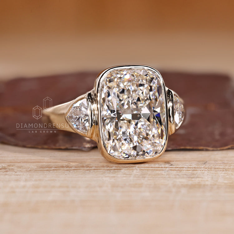 Cushion diamond ring with bezel and cathedral setting.