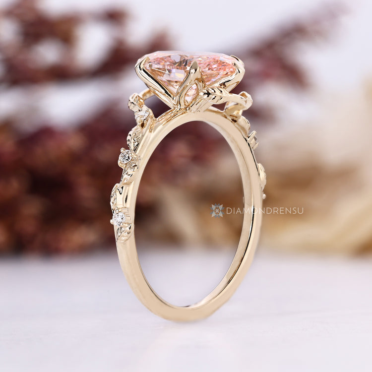 Oval cut diamond ring with tulip setting and side stones.