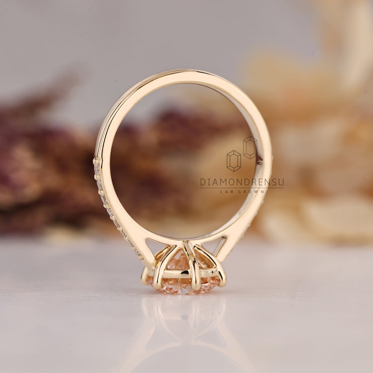 Pink diamond engagement ring with tapered shank.
