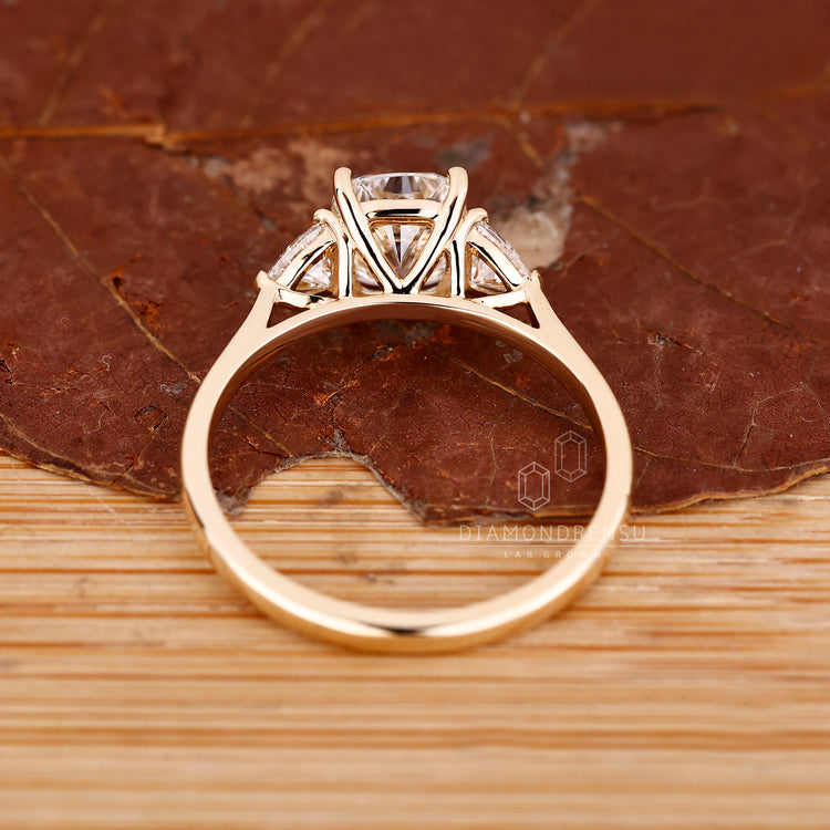 Cushion cut diamond ring with trillion sides and prongs.
