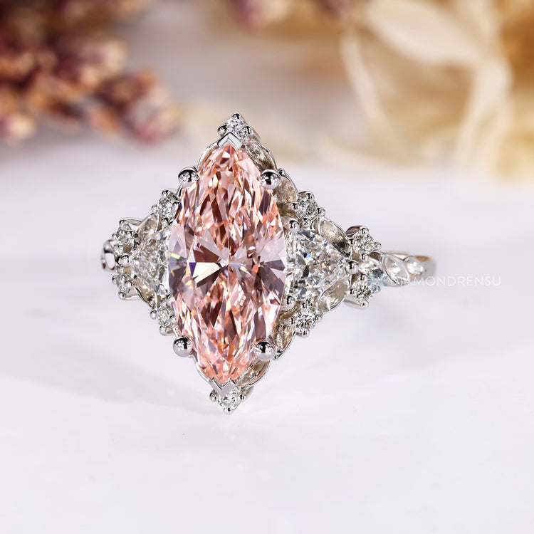 Lab grown marquise diamond ring with four claw prongs.