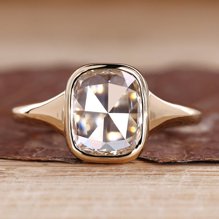 Bezel engagement ring with cushion rose cut diamond.