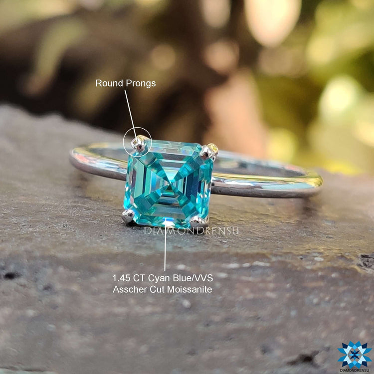 Elegant moissanite ring in white gold with bold cyan blue color.