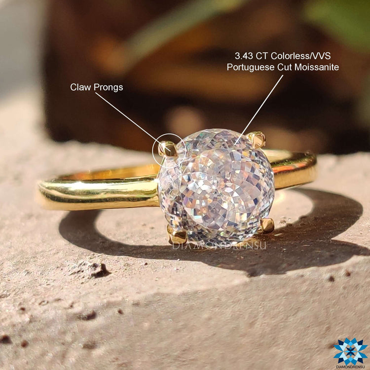 Elegant solitaire ring with Portuguese cut moissanite.