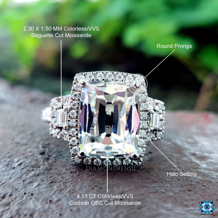 Moissanite halo ring with elongated cushion center stone.