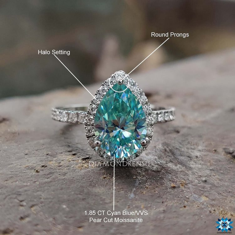 White gold moissanite ring with handcrafted detail and halo setting.