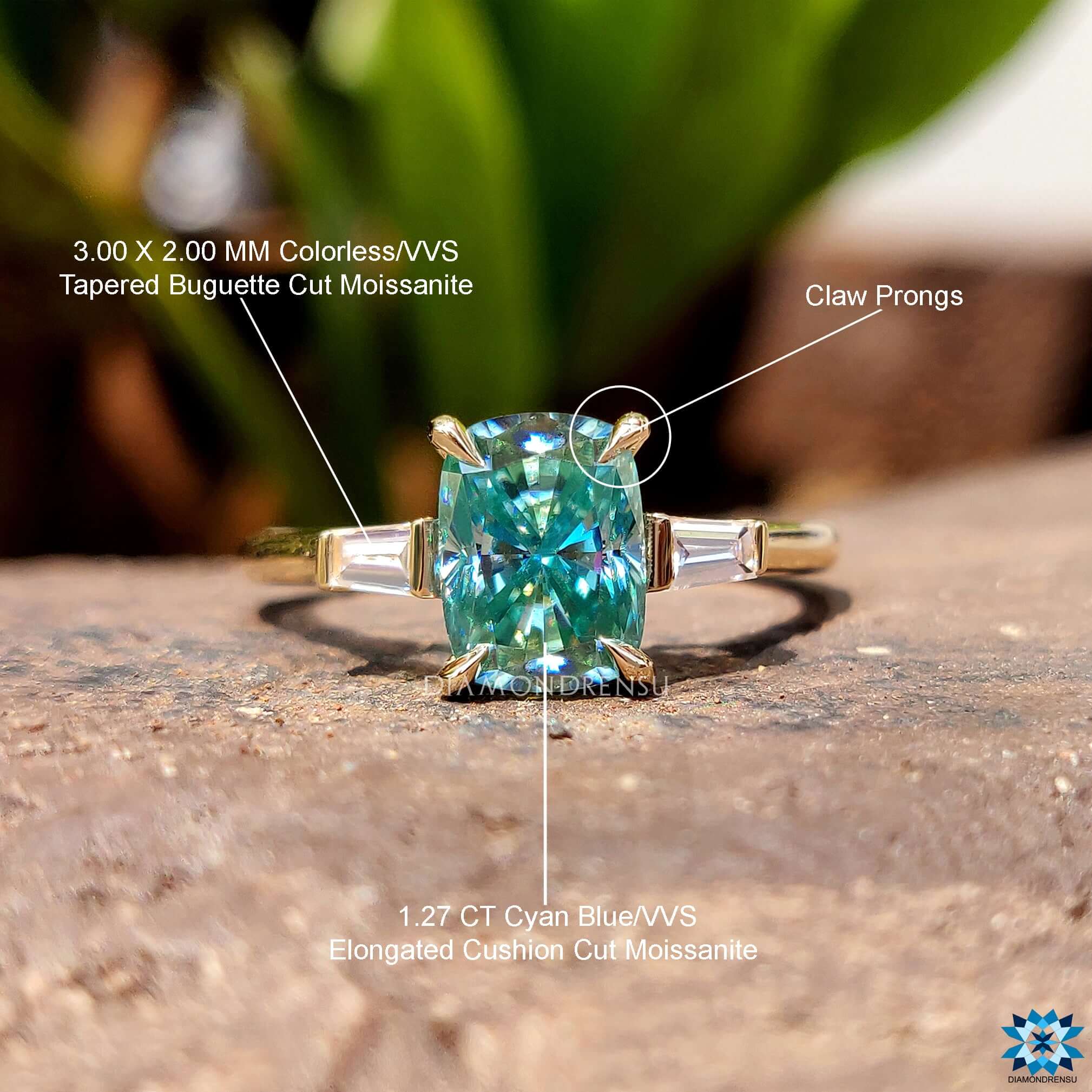 Cyan moissanite ring with baguette accents in yellow gold.
