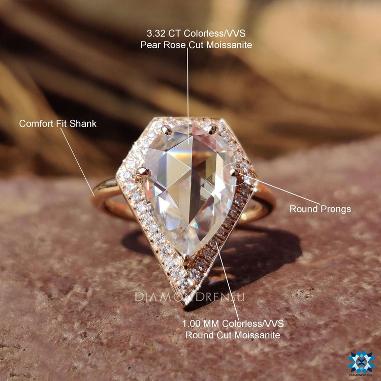 Rose gold engagement ring with pear center stone.