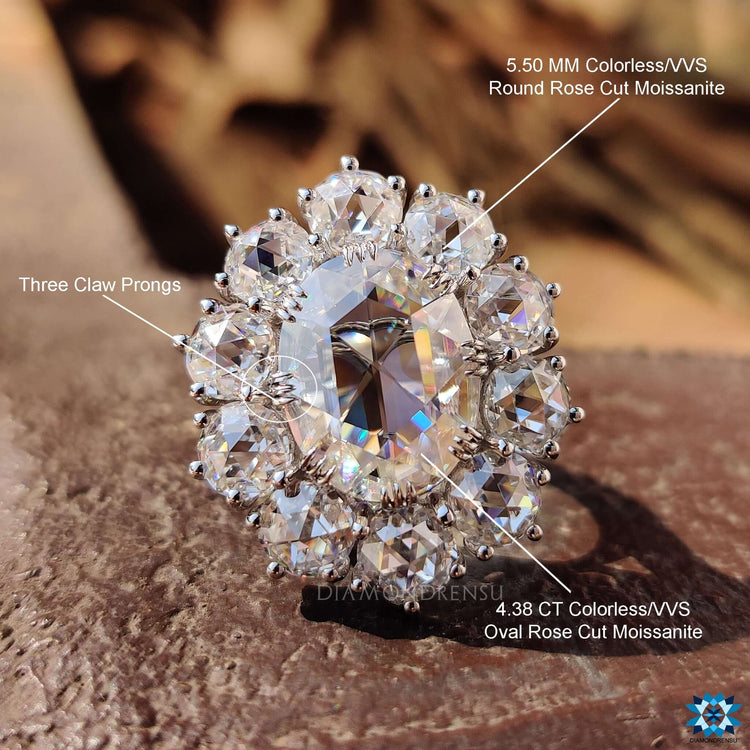 Moissanite engagement ring designed with cluster halo and fishtail prongs.