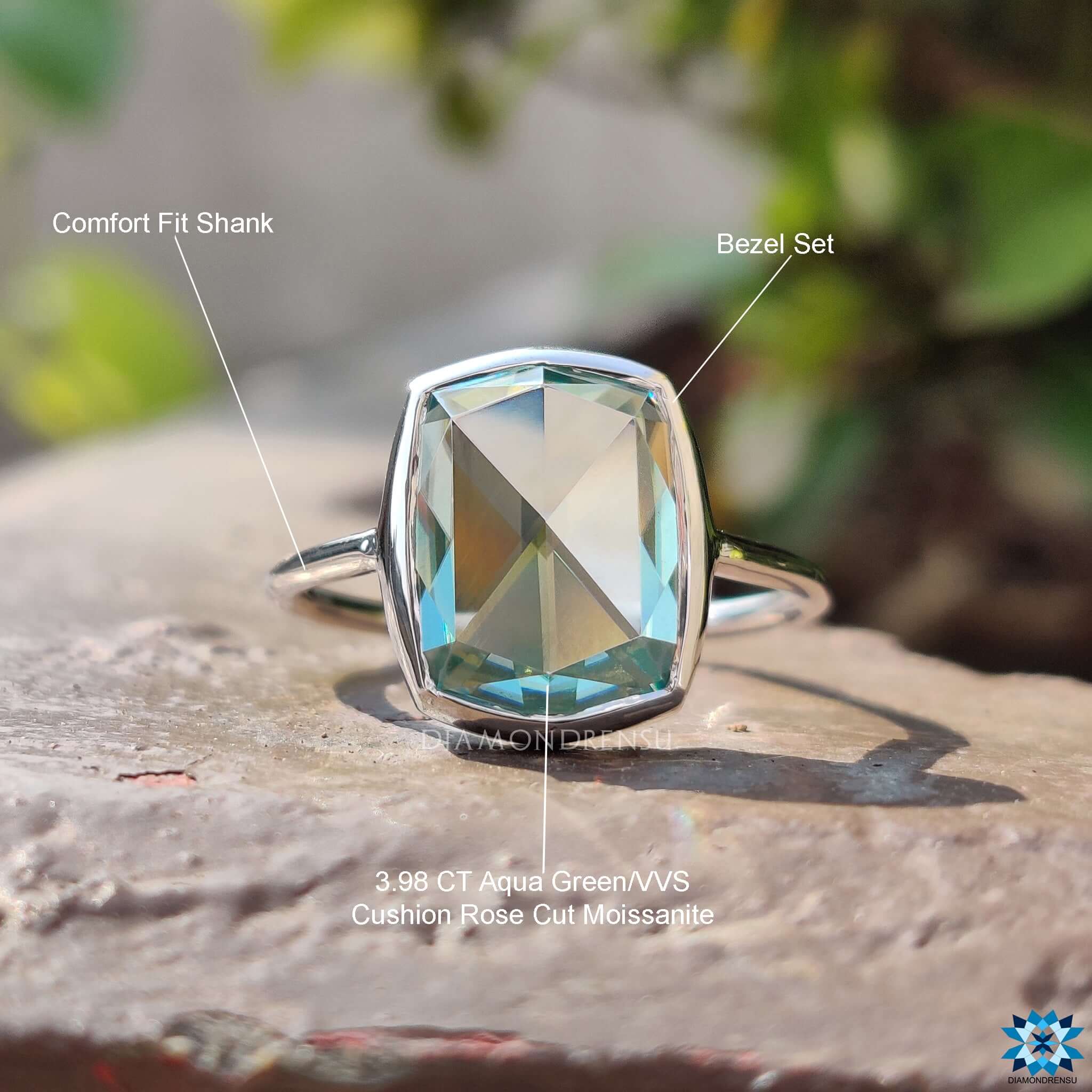 White gold engagement ring with bezel set cyan blue moissanite.