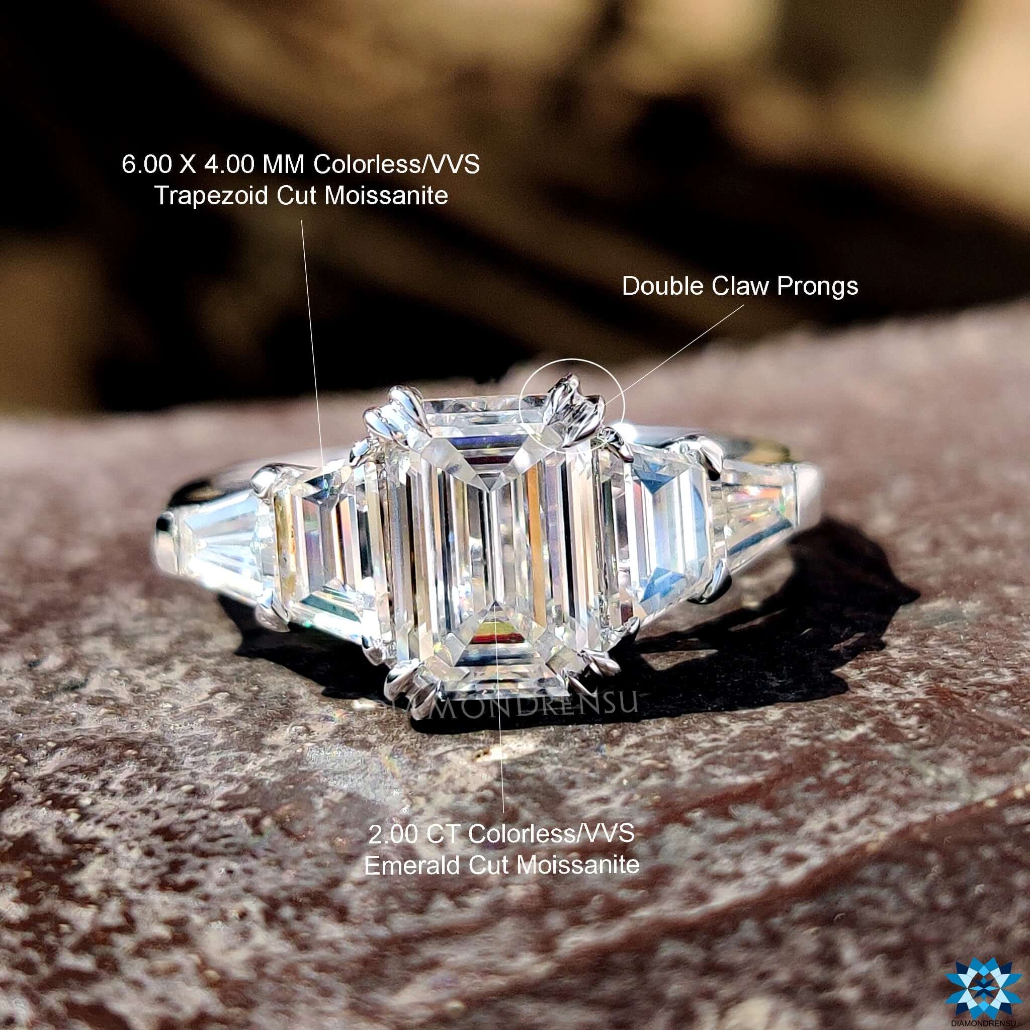 White gold emerald moissanite ring with trapezoid sides.