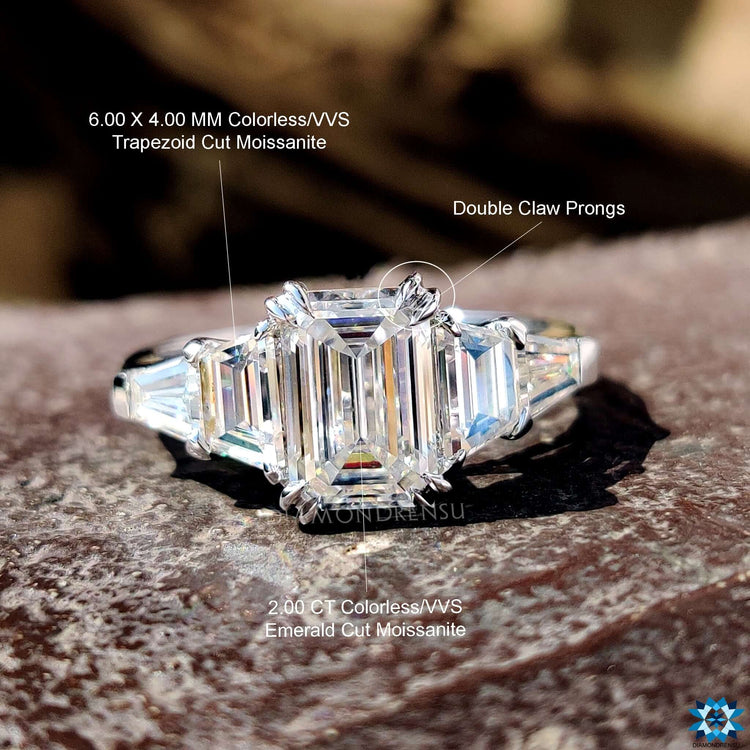White gold emerald moissanite ring with trapezoid sides.