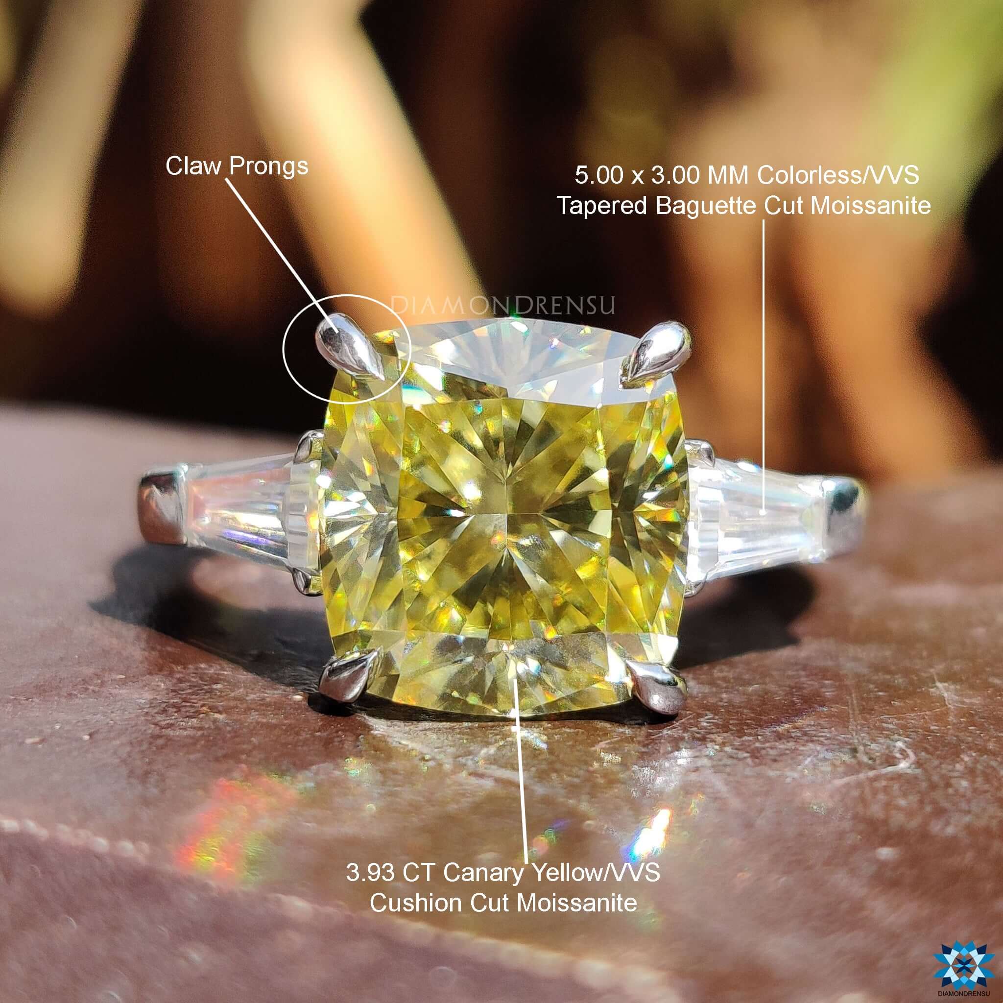 Cushion cut moissanite ring with side baguette stones.
