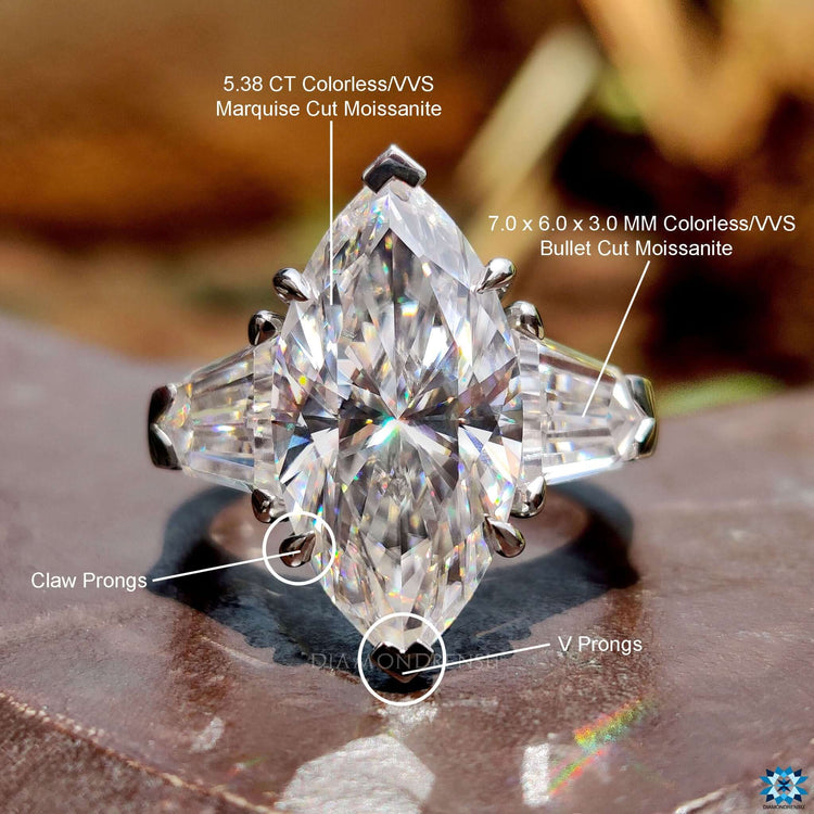 Marquise moissanite ring with side bullet stones and V prong details.