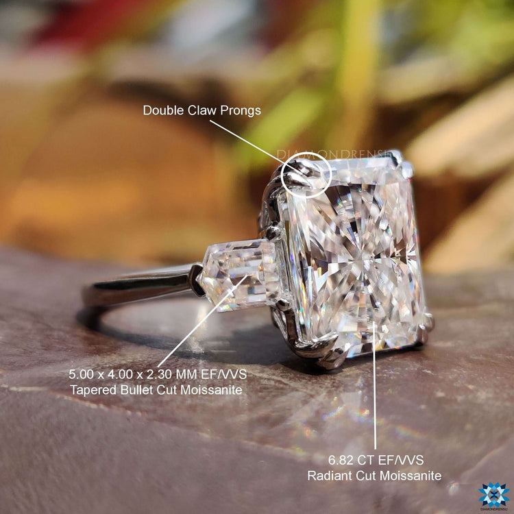 Bullet cut moissanite ring with radiant centerpiece design.